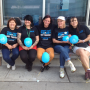 Zoë Dodd, Hepatitis C Program Coordinator (second from left), sits with staff and volunteers marking World Hepatitis Day.