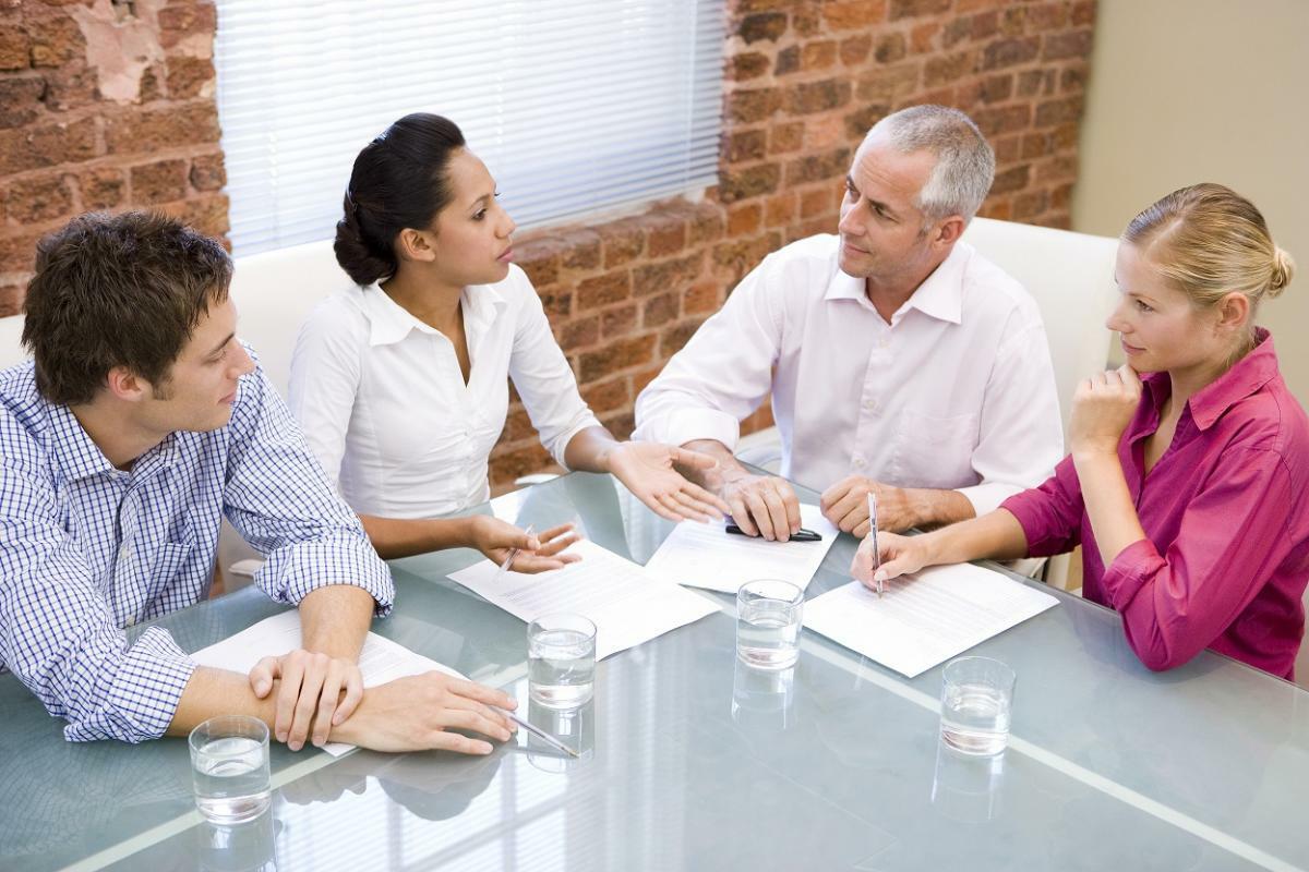 group of people talking around at table